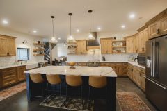 Custom Amish Kitchen Cabinetry, Rustic Maple in Husk Stain on Perimeter, Maple Painted Black on Island and Hood