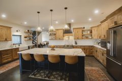Custom Amish Kitchen Cabinetry, Rustic Maple in Husk Stain on Perimeter, Maple Painted Black on Island and Hood, Quartz Countertops in Calacatta Kingston