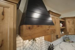 Custom Amish Kitchen Cabinetry, Rustic Maple in Husk Stain on Perimeter, Maple Painted Black on Hood, Quartz Countertops in Calacatta Kingston